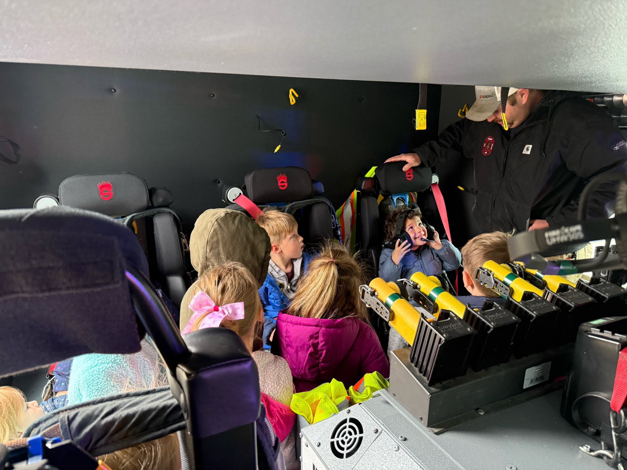 Children learning about rescue equipment inside an Apalachin apparatus