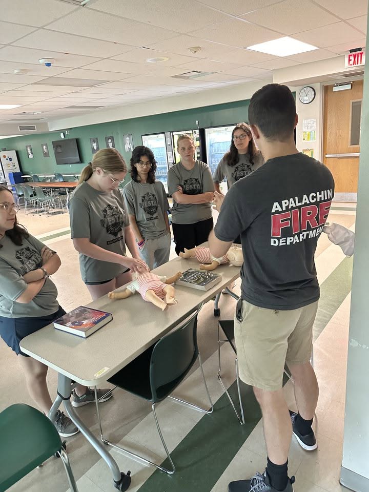 An Apalachin member teaching CPR to local students